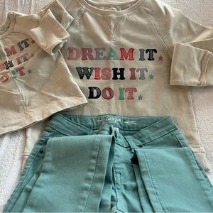 crew necks , a baby crew neck and a pair of jeans.